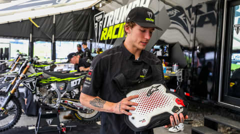 Triumph's Austin Forkner holding Alpinestars' TechAir MX airbag system