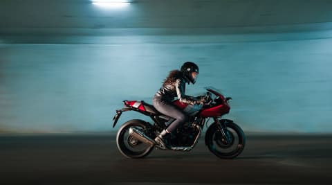 Thruxton 400 in Lava red gloss and aluminium silver with a rider in action