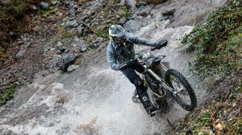 Man riding TF 250-E through water
