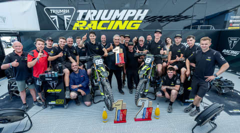 Group of people stood around Triumph TF 250 X