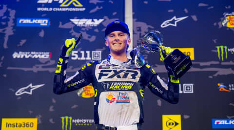 Deacon Denno celebrating championship with a trophy in his hand