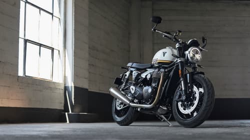 Triumph Speed Twin 1200 parked next to a window