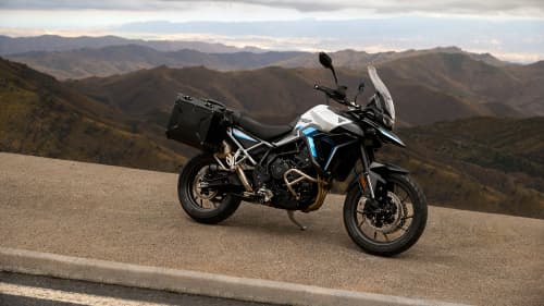 Side view of parked Triumph Tiger 900 GT Pro Alpine Edition overlooking mountains