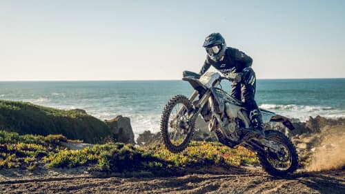 Rider on Triumph TF 450-E on one wheel