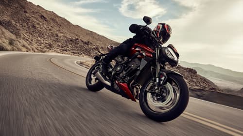 Angled side view action shot of Triumph Street Triple RS