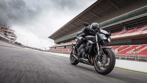 Triumph Street Triple RS motorcycle riding with speed on race track