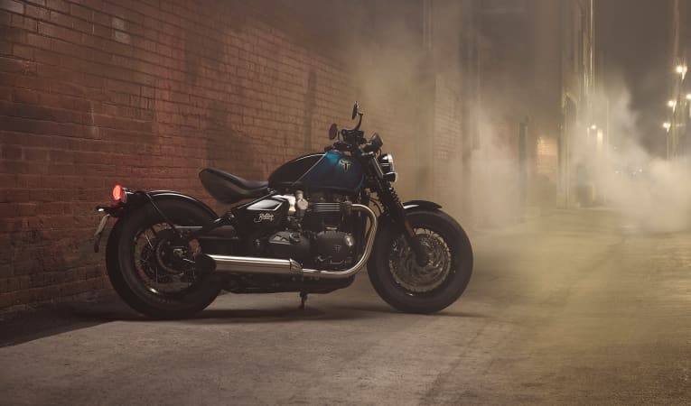 Triumph Bonneville Bobber in Intersteller Blue with a smokey background