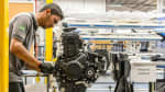 Man assembling Triumph motorcycle engine