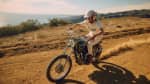 Man on retro triumph bike in the desert