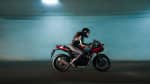 Thruxton 400 in Lava red gloss and aluminium silver with a rider in action