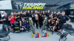 Group of people stood around Triumph TF 250 X