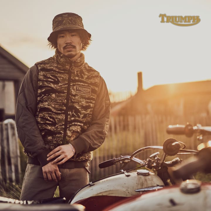 Model wearing Triumph SS24 collection, sykes fleece, kapok bucket hat and crown bomber.