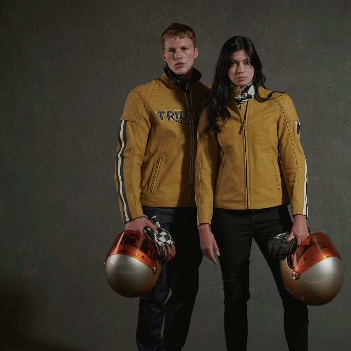 Male and Female model wearing gold Triumph Braddan jackets