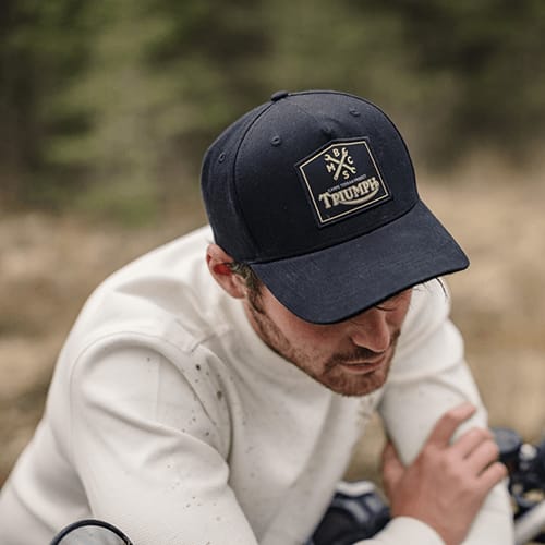 Triumph's collaboration with Bike Shed carpe terram cap in black with gold detailing