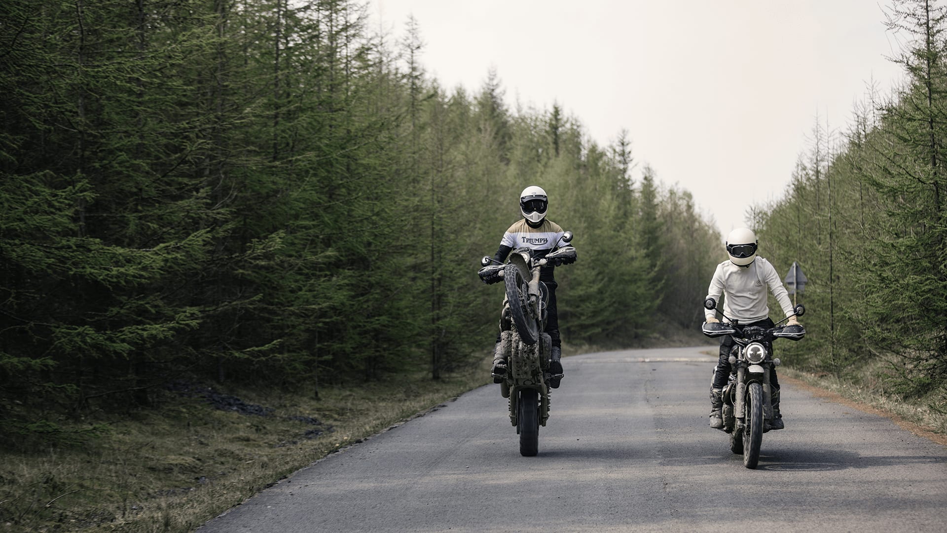 Triumph's collaboration with Bike Shed featuring two Scrambler 1200s with one doing a wheelie