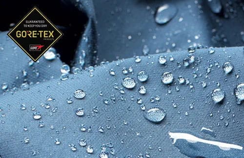 Triumph Gore Tex garment with water droplets covering the surface with Gore Tex logo overlay