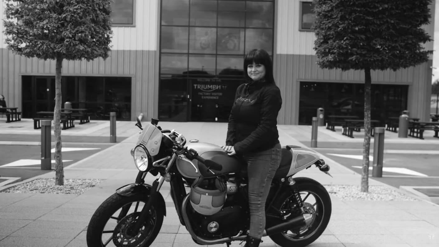Black & white shot of Lara Collins on her Triumph motorcycle ready for The Distinguished Gentleman's Ride