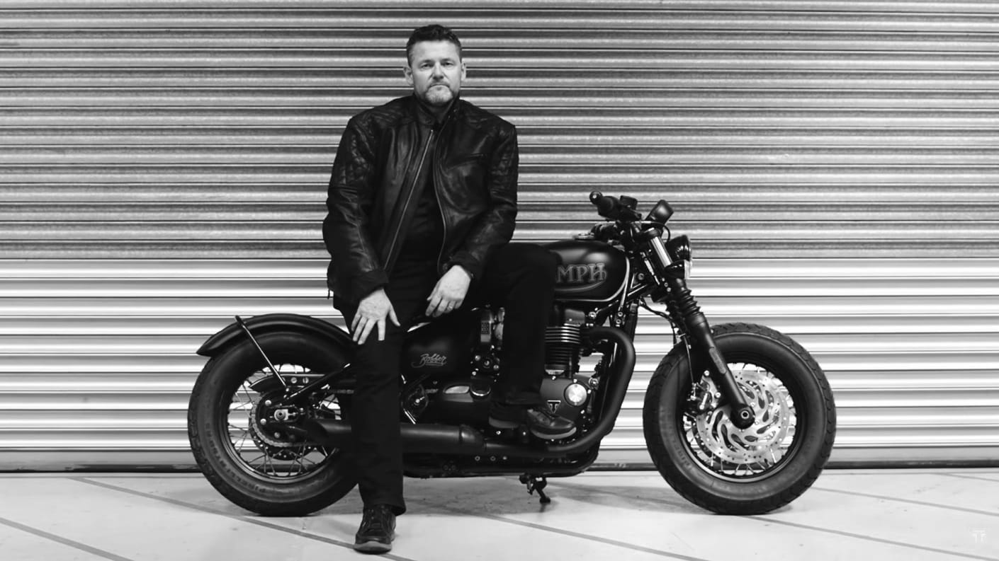 Black & white shot of Mark Perkins with his Triumph motorcycle ready for The Distinguished Gentleman's Ride