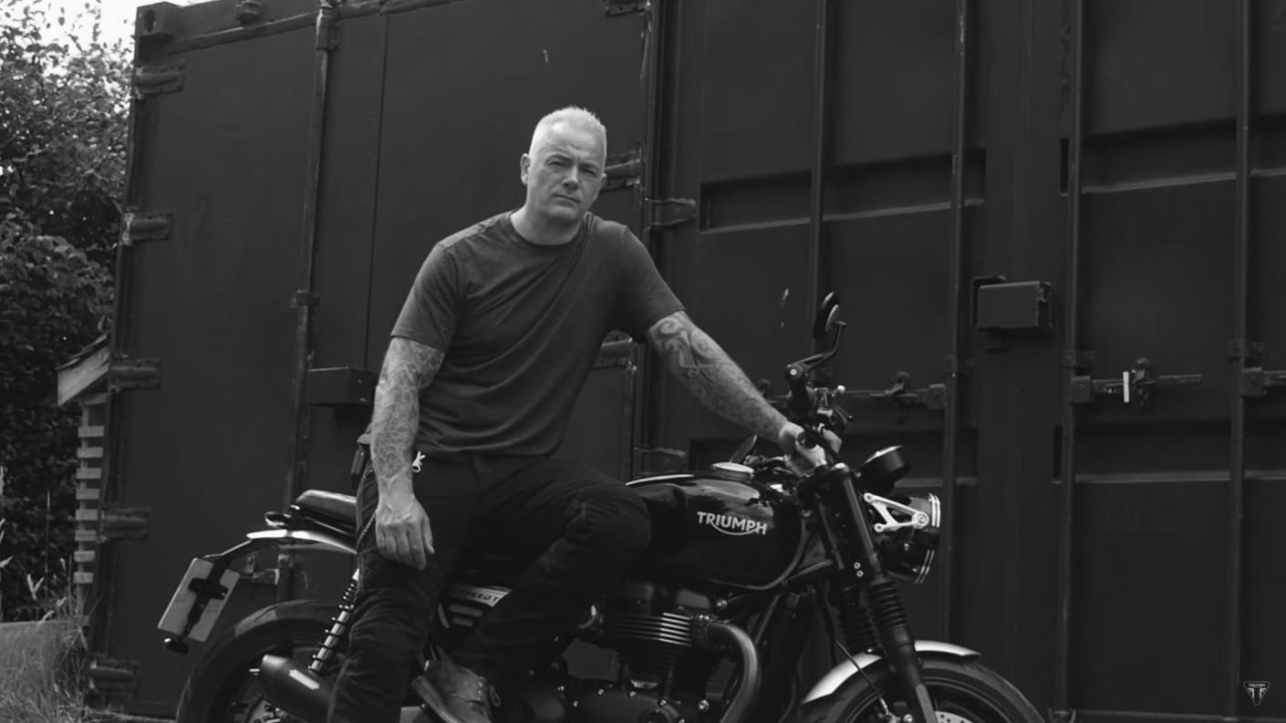 Black & white shot of Mark Richardson on his Triumph motorcycle ready for The Distinguished Gentleman's Ride