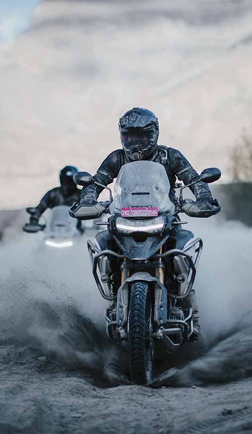 Triumph Tiger 1200 Rally Pro being ridden through the Himalayan Mountain range