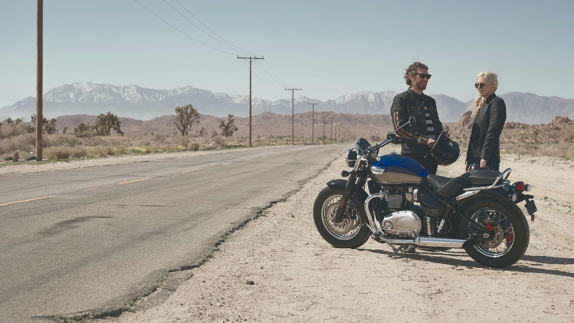 Triumph Speedmaster rider and pillion parked