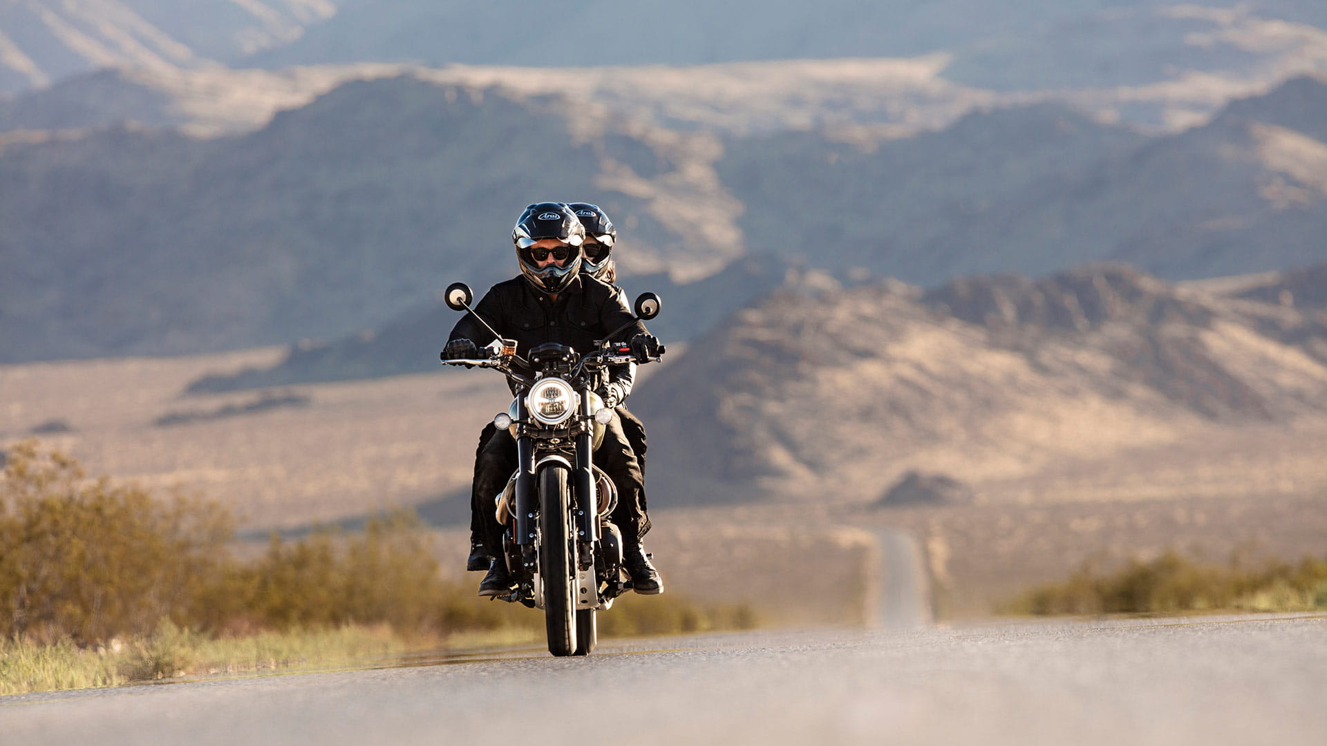 A rider on the Triumph Scrambler 1200 riding along a scenic route