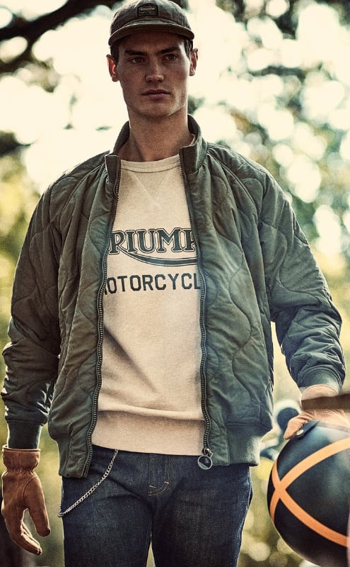 Man in forest wearing Triumph Lifestyle Crown Jacket