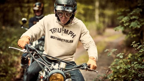 Man on Triumph bike wearing quarter zip