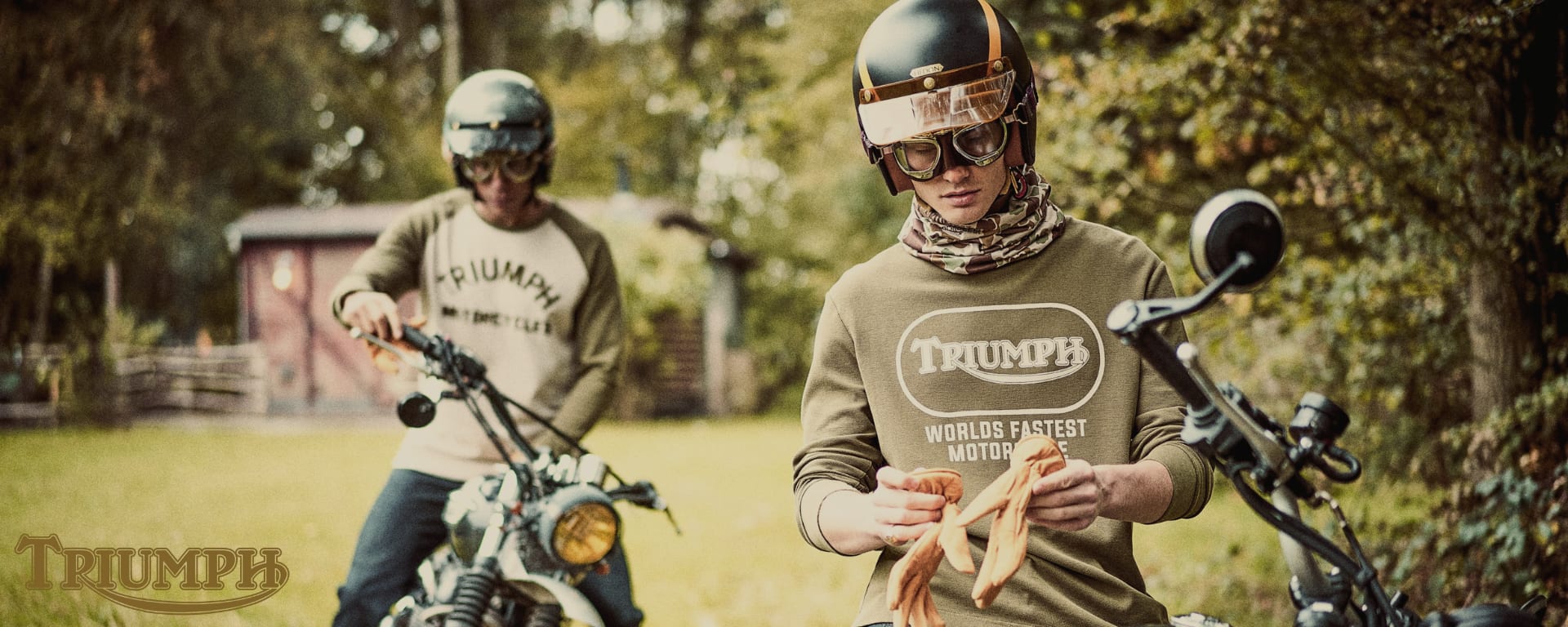 Men in forest on motorcycle wearing Triumph Lifestyle Autumn Winter 23 Collection long sleeve t-shirts)