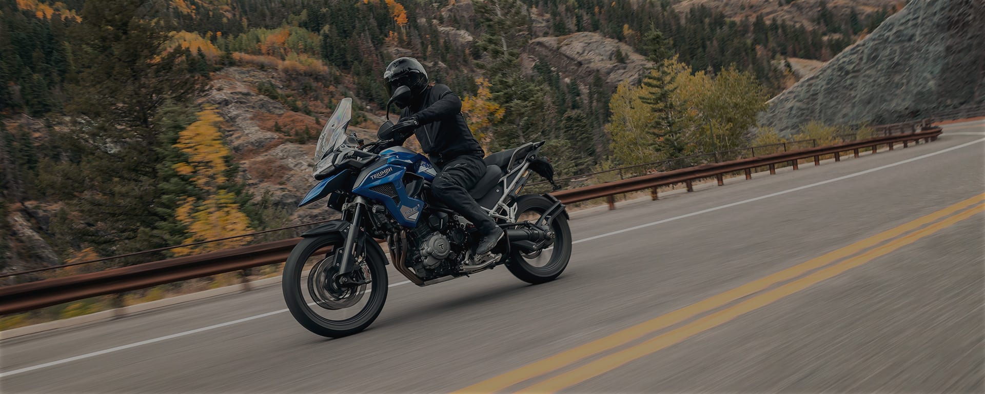 Triumph Tiger 1200 GT Pro riding on mountain road)