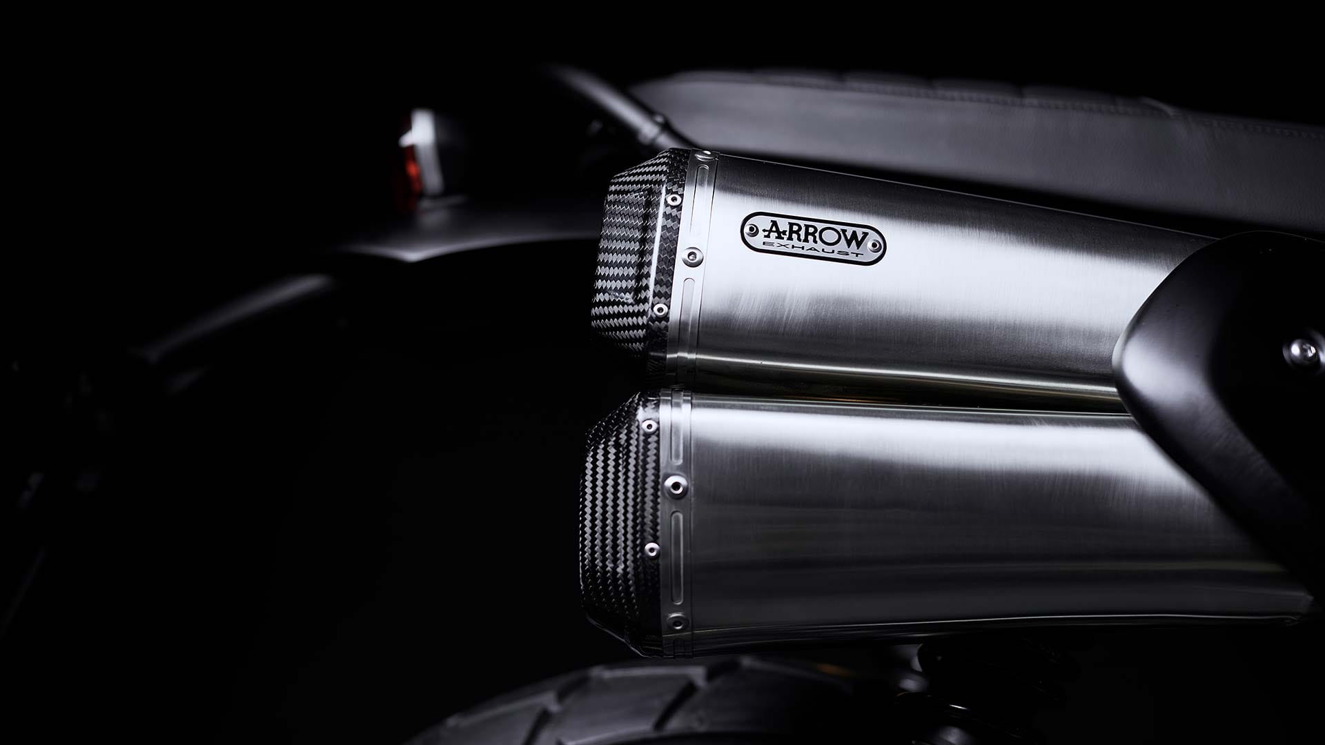 Close up of the Triumph Scrambler 1200 Bond Edition Arrow silencer with carbon fibre end caps