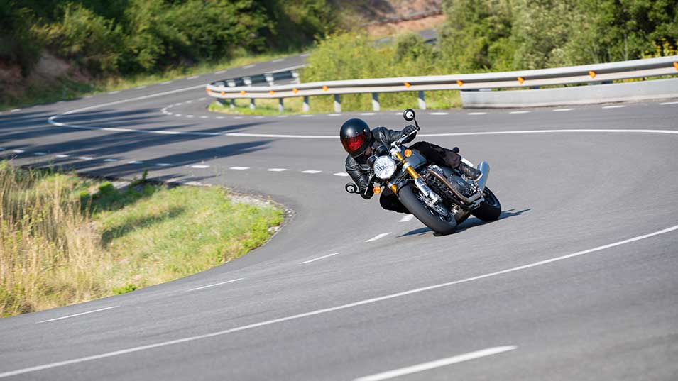 Rider flowing through sharp countryside bends on the new Triumph Thruxton RS