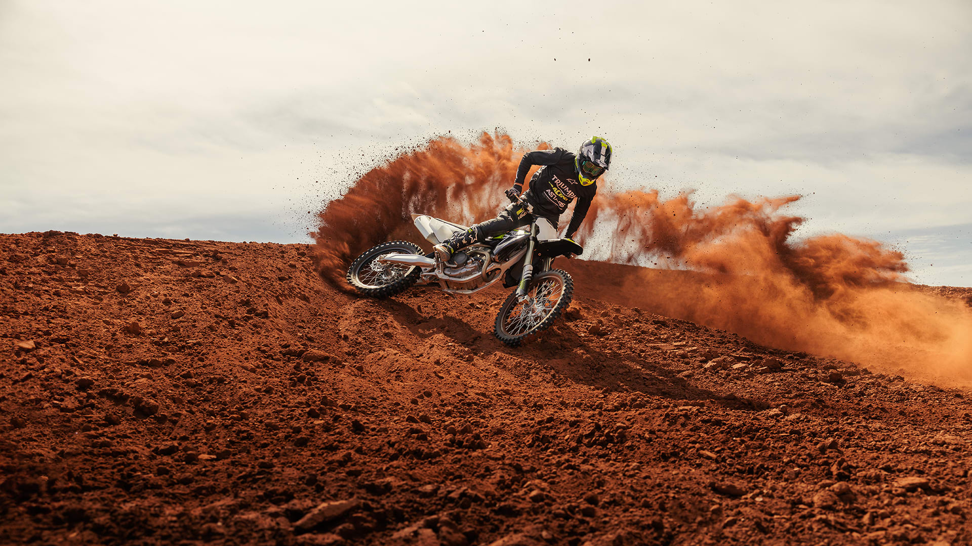 Triumph TF 250-Xs riding on Motocross track with dirt cloud