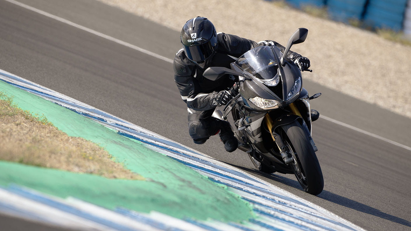 Triumph Daytona Moto2TM 765 motorcycle (EU and Asia Edition) riding around the corner of a race track at speed