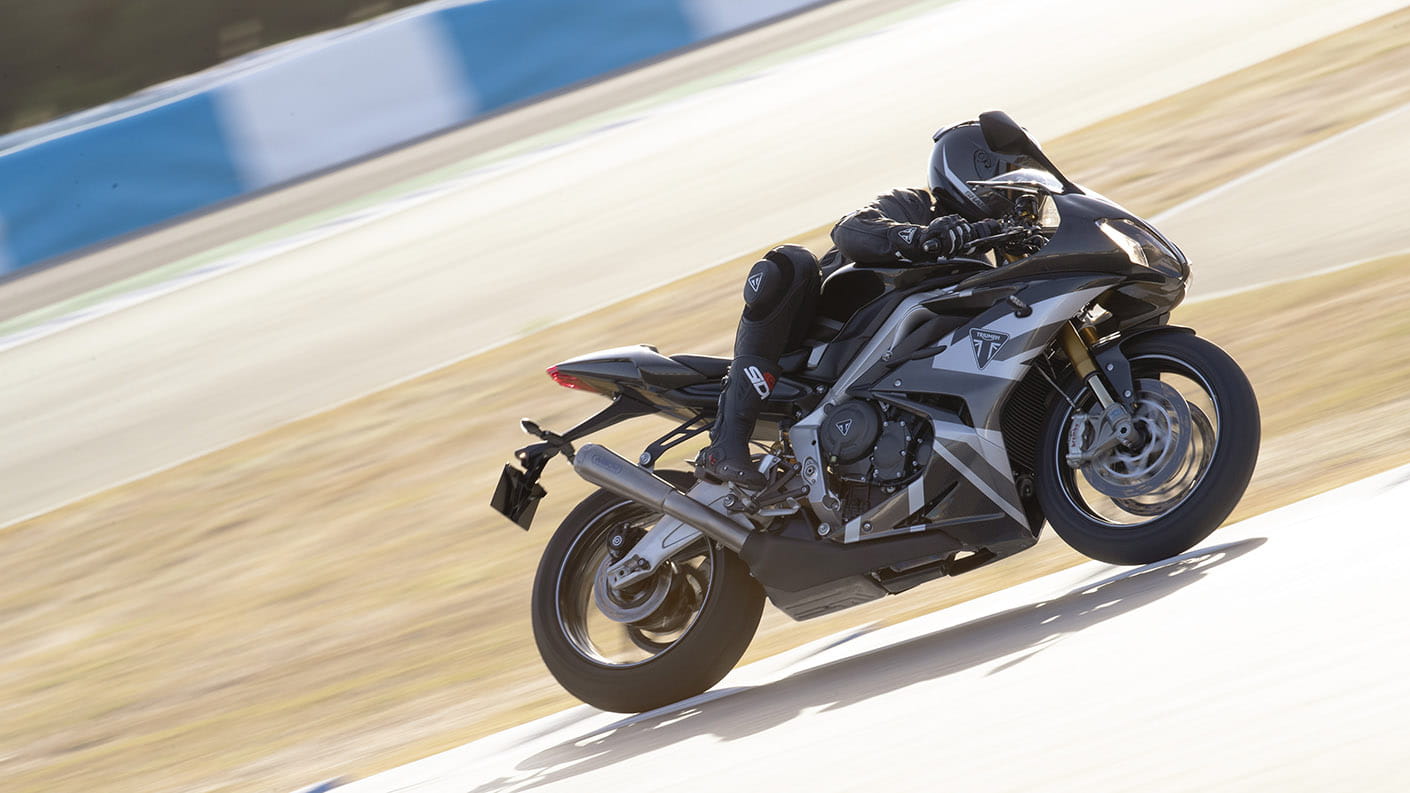 Triumph Daytona Moto2TM 765 motorcycle (EU and Asia Edition) riding around the corner of a race track at speed