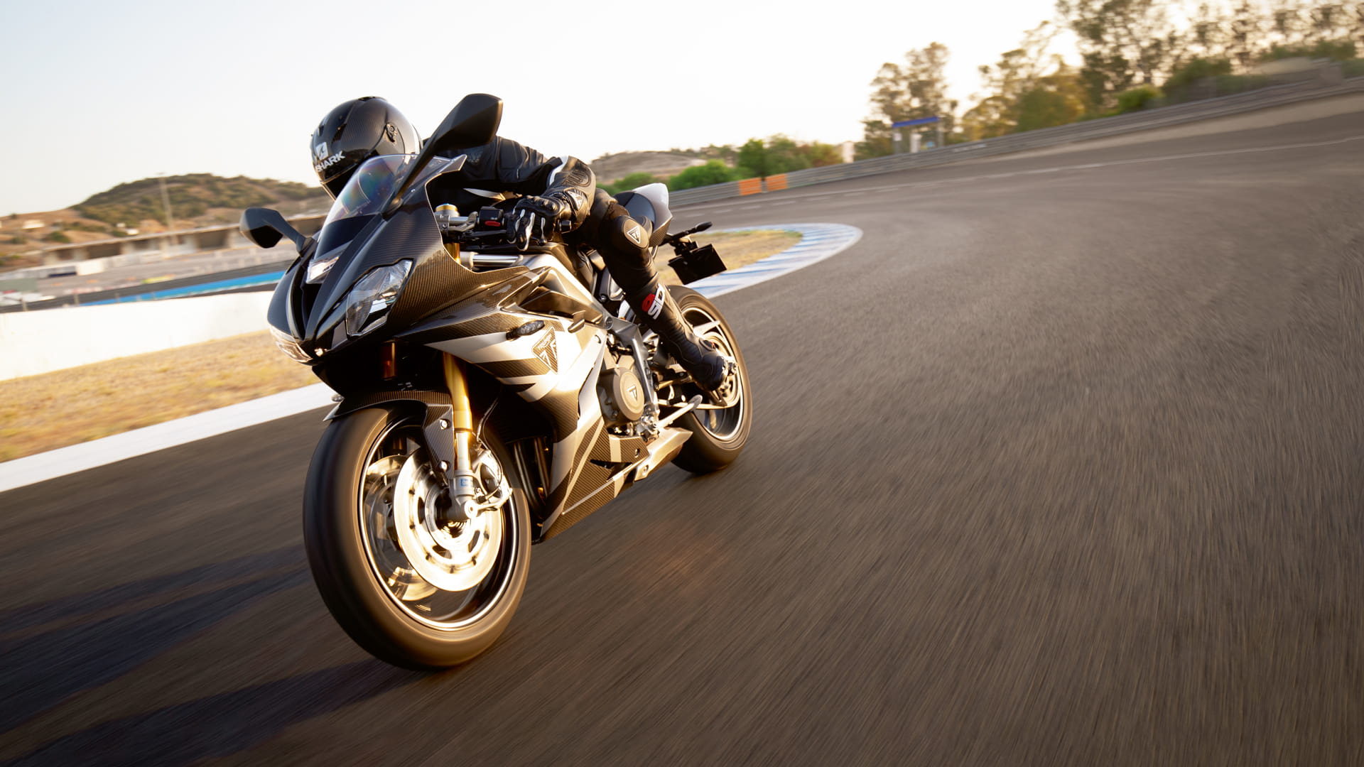 Triumph Daytona Moto2TM 765 motorcycle (EU and Asia Edition) racing around a race track at speed