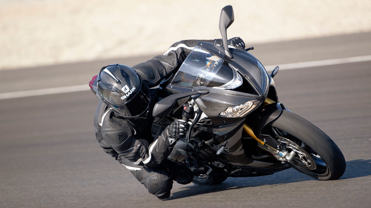 Triumph Daytona Moto2TM 765 motorcycle (EU and Asia Edition) riding around the corner of a race track at speed