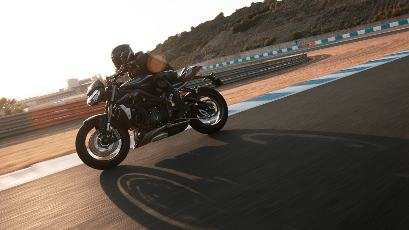 Sunrise action shot of Triumph Street Triple RS in Silver Ice on a racetrack