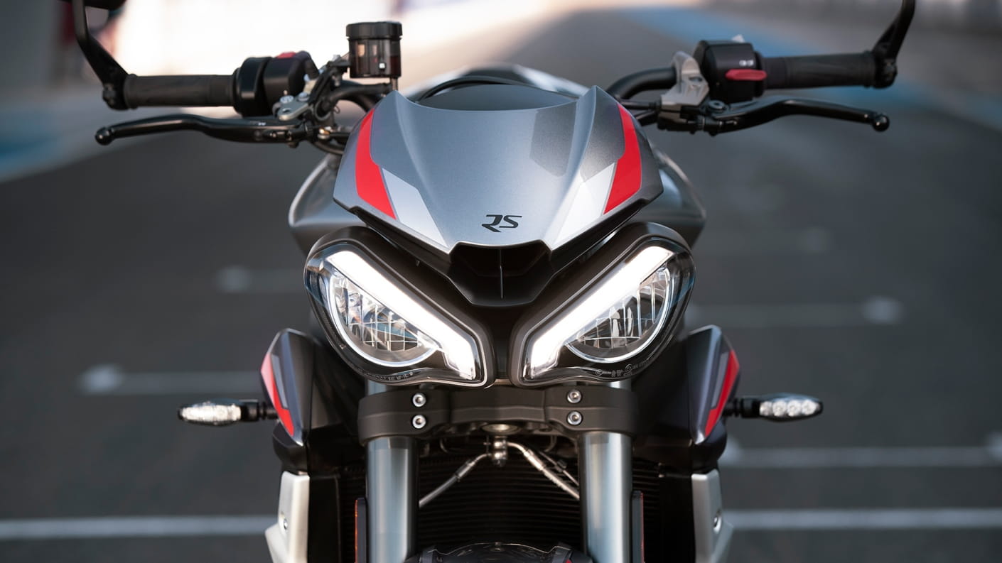 Close-up front shot of Triumph Street Triple RS in Silver Ice beautifully distinctive full-LED twin headlight
