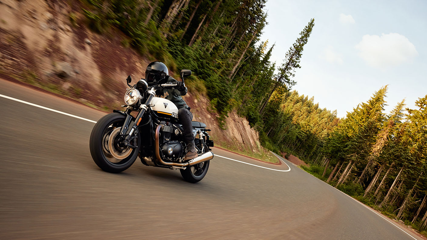 Triumph Speed Twin 1200 riding shot through a forest