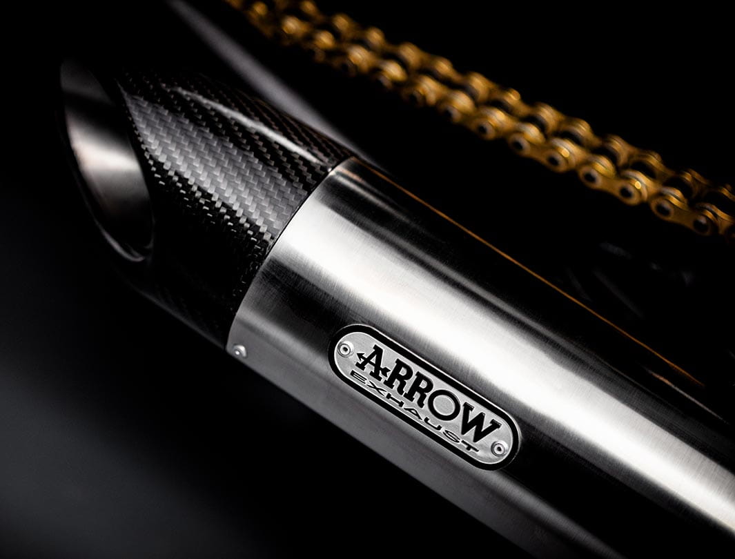 Close-up shot of the Triumph Bobber TFC's Arrow titanium silencers with carbon fibre end caps