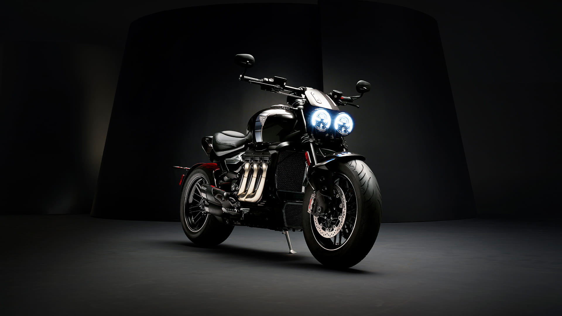 Triumph Rocket 3 TFC front three quarters featuring iconic three header exhaust run with premium carbon fibre detailing