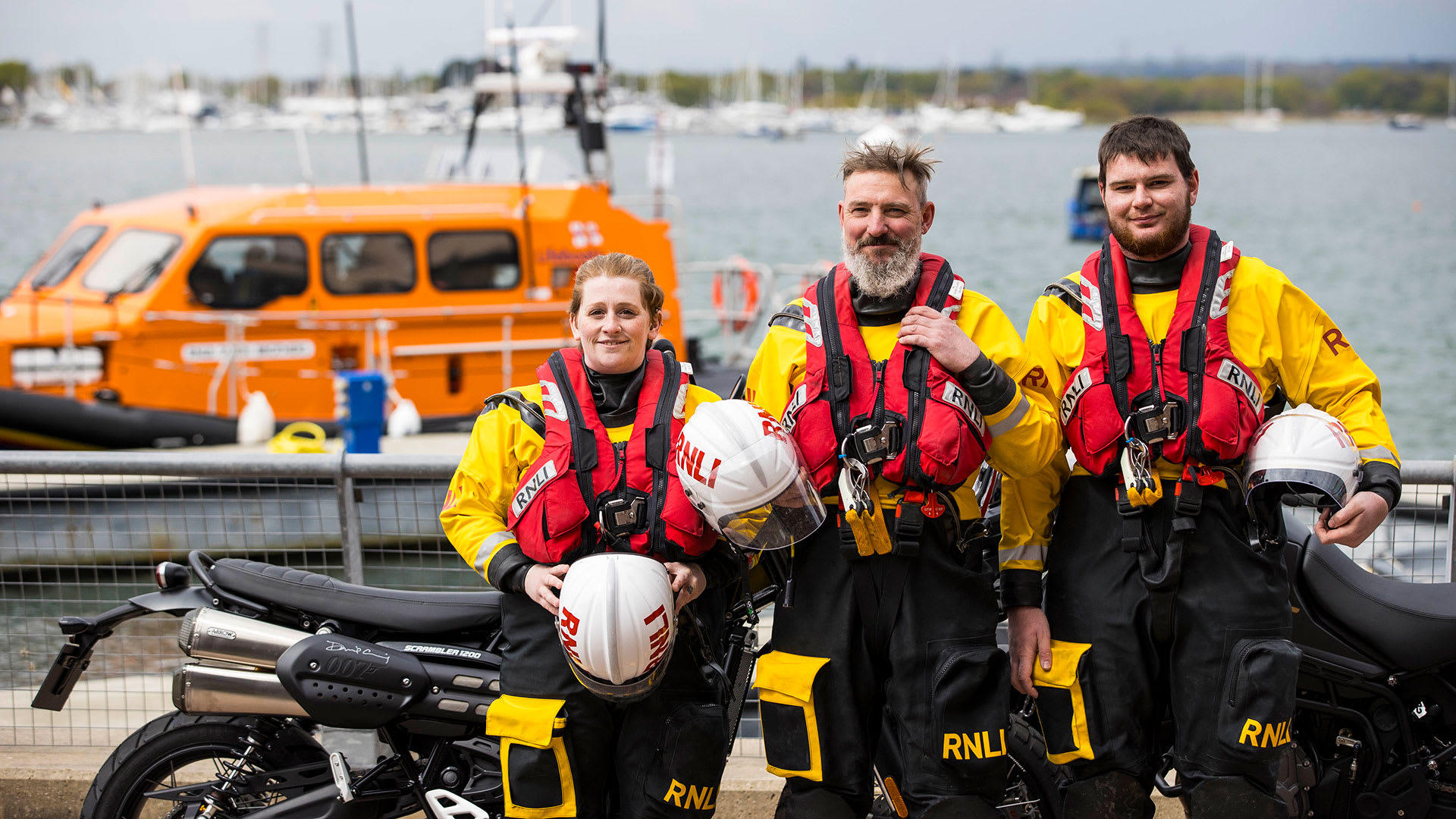 Triumph Scrambler 1200 and Tiger 900 Bond Editions with RNLI at the dock