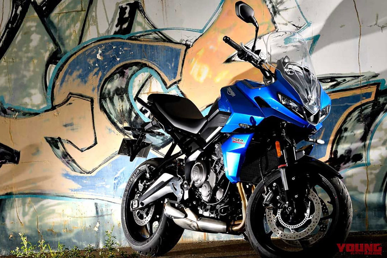Triumph Tiger Sport 660 leaning against wall with graffiti art