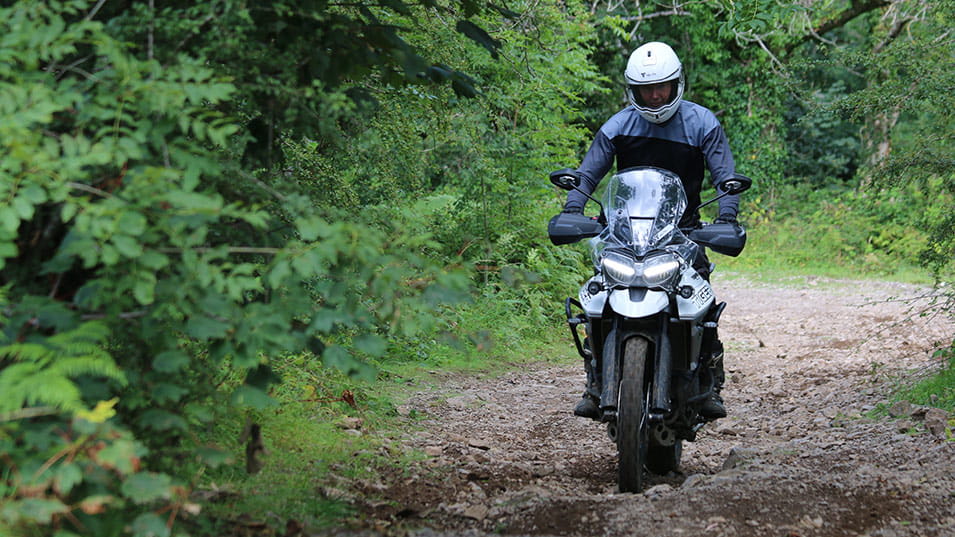 A solo rider wearing Triumph's off-road clothing gear on the Tiger 800
