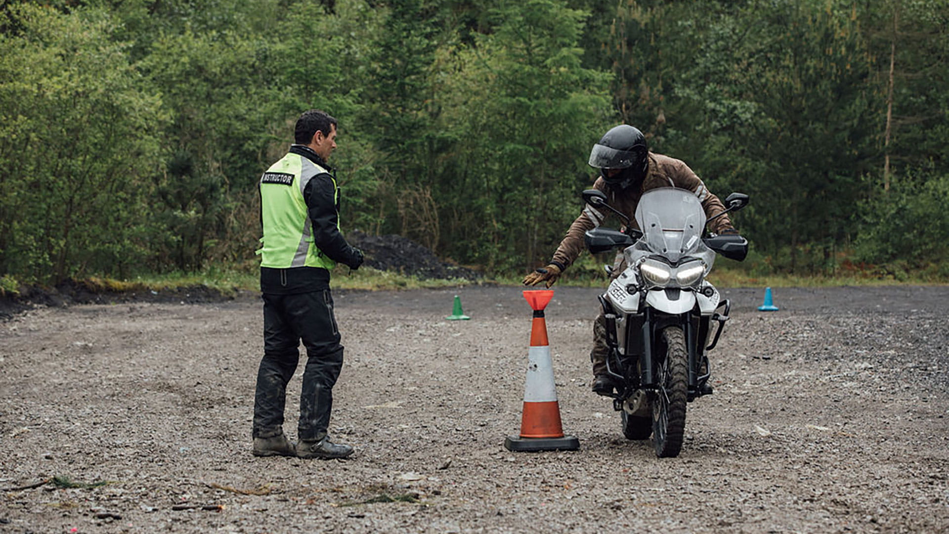 Trainer instructing a rider on basic skills of riding a Tiger 800