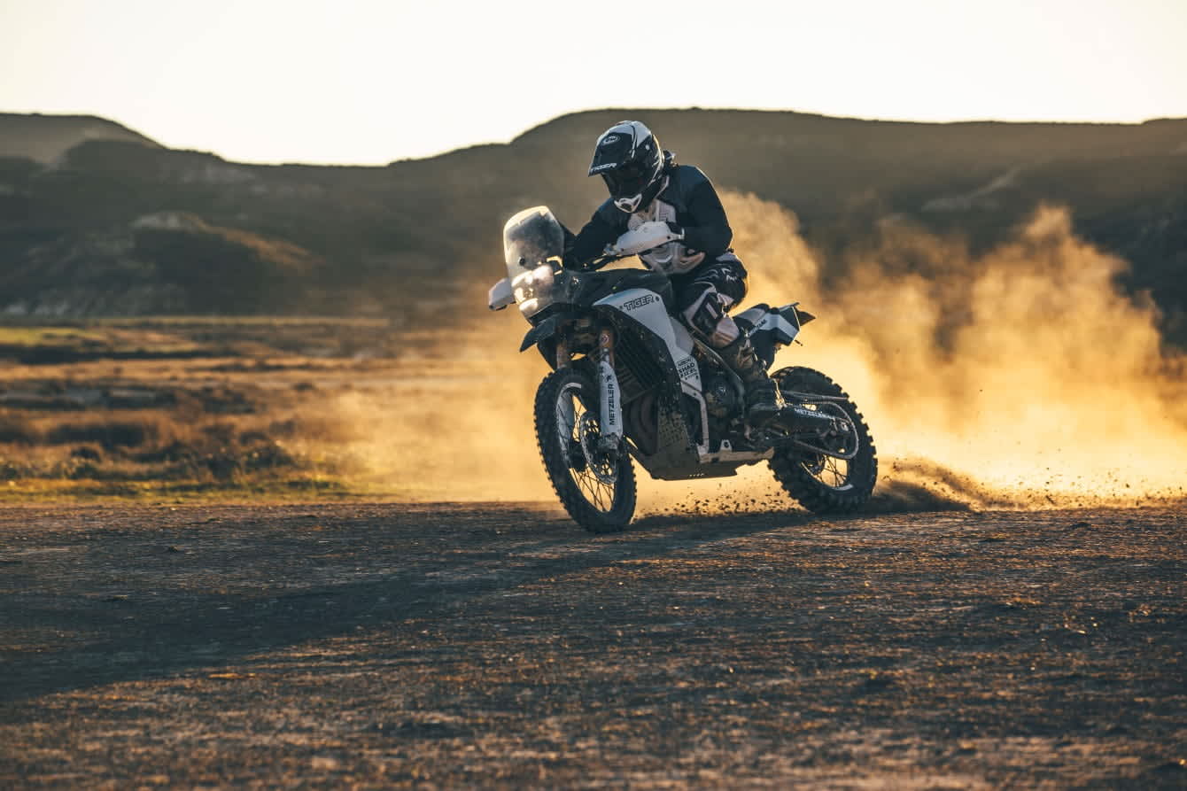 Triumph Tiger sunset shot with mist illuminating the background