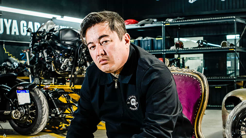Triumph Originals Brazil Shibuya Garage team member sitting on a chair in a workshop