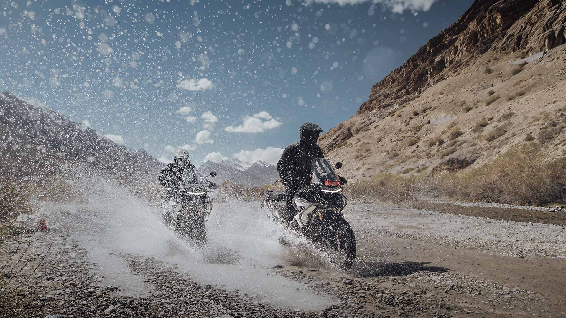 Tiger 1200 Rally Pros splashing through a river