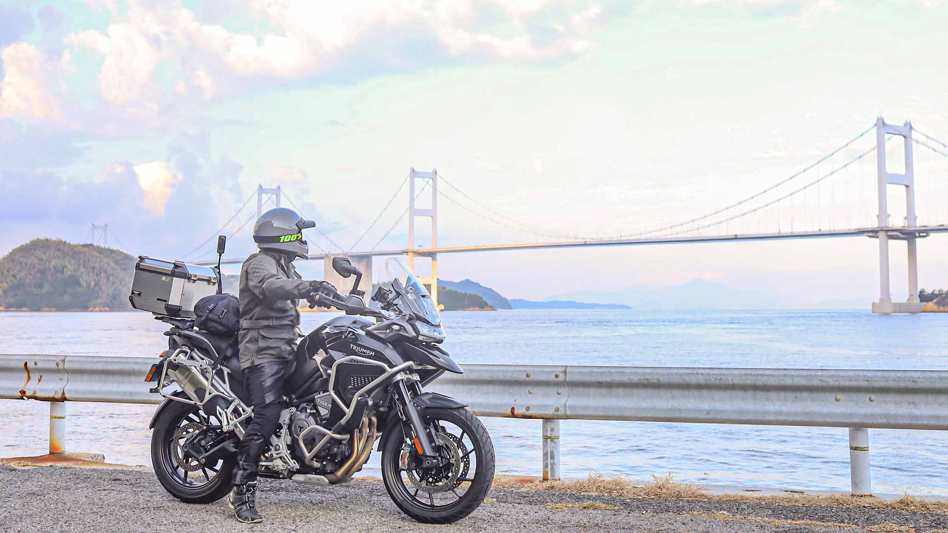 Tiger 1200 GT with rider looking over a bay